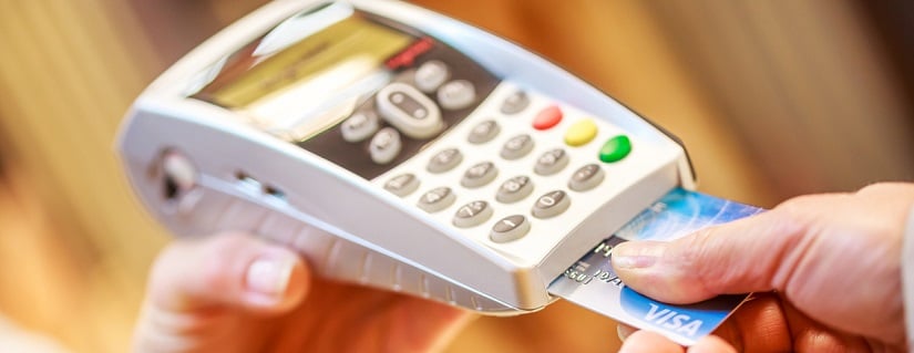 Une personne qui utilise une carte bancaire dans un distributeur de billets