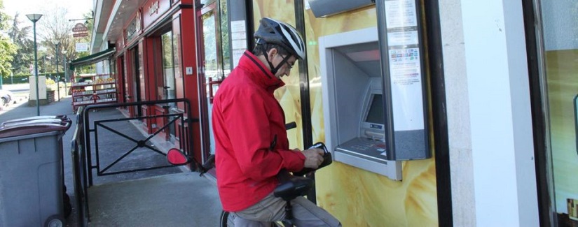 Un homme vient de retirer son argent sur le guichet automatique Société Générale.
