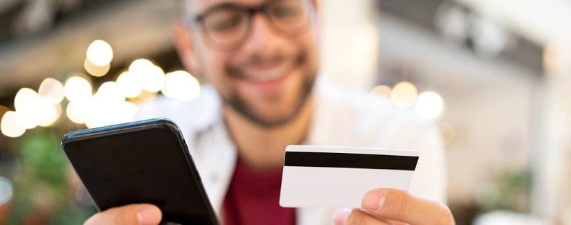 Mise au point sélective sur les mains, le téléphone et la carte de crédit