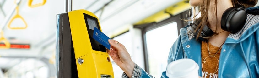 Femme payant sans contact par carte bancaire pour les transports en commun dans le tramway